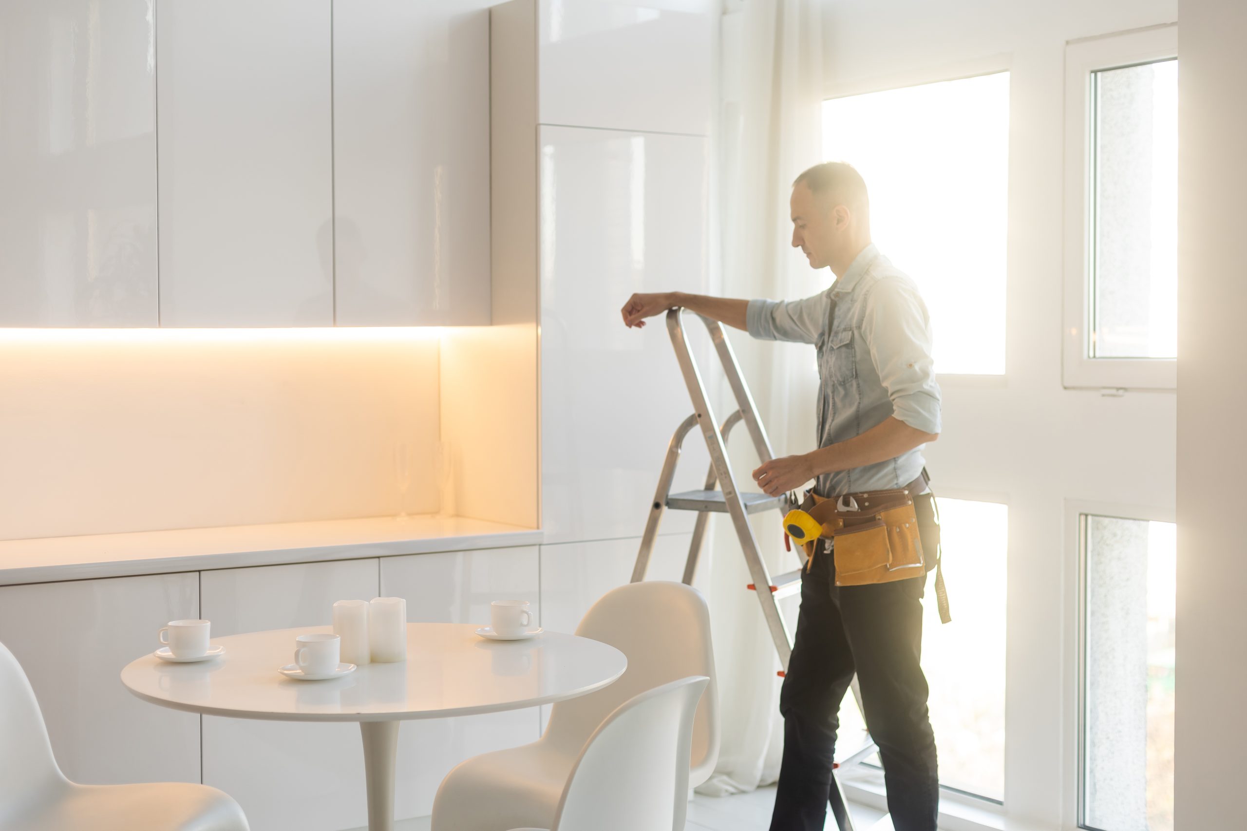 Builder handyman with construction tools. House renovation background